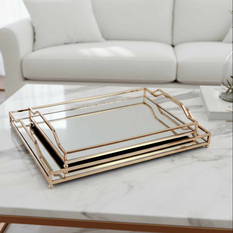 Set of two gold-trimmed glass trays on a white background