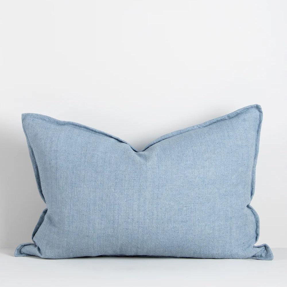 Chambray blue linen cushion on a white background