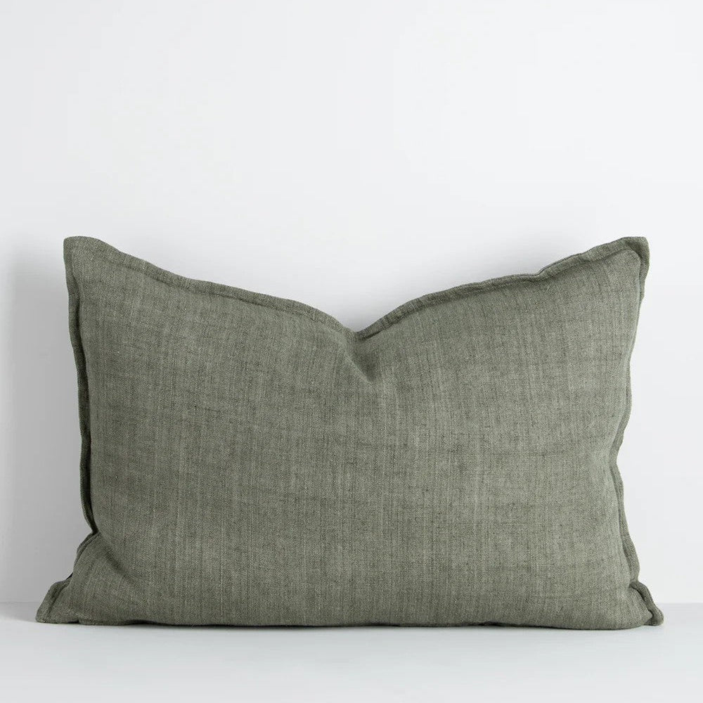 Moss green linen cushion on a white background