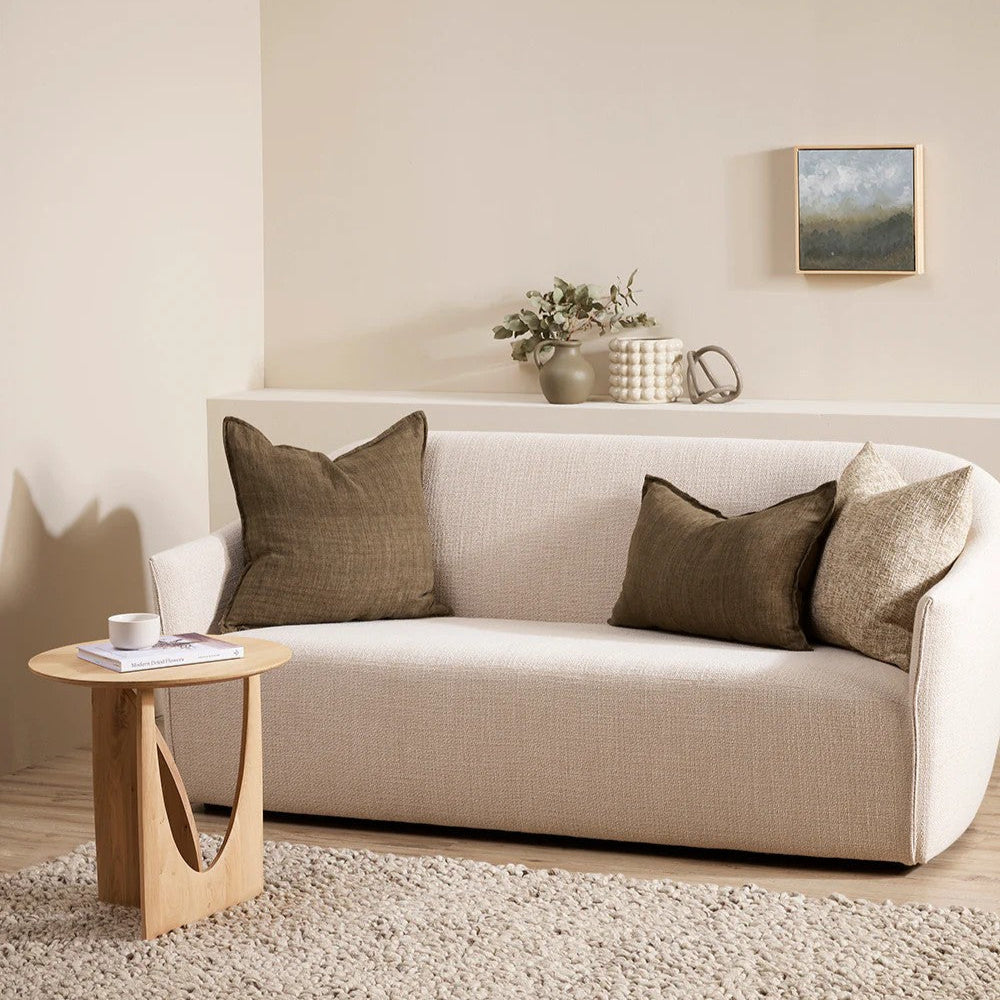Beige sofa with clove linen cushions in a living room setting