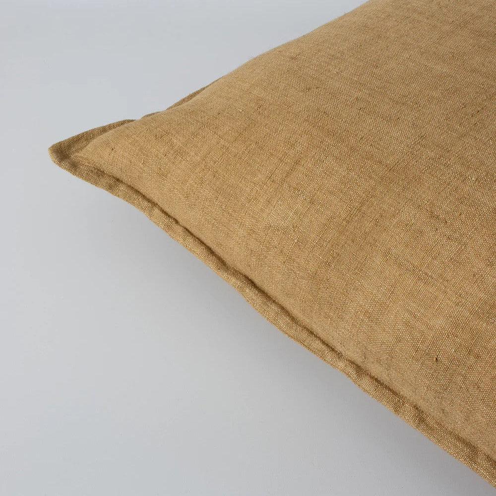 Closeup of cumin linen cushion on a white background