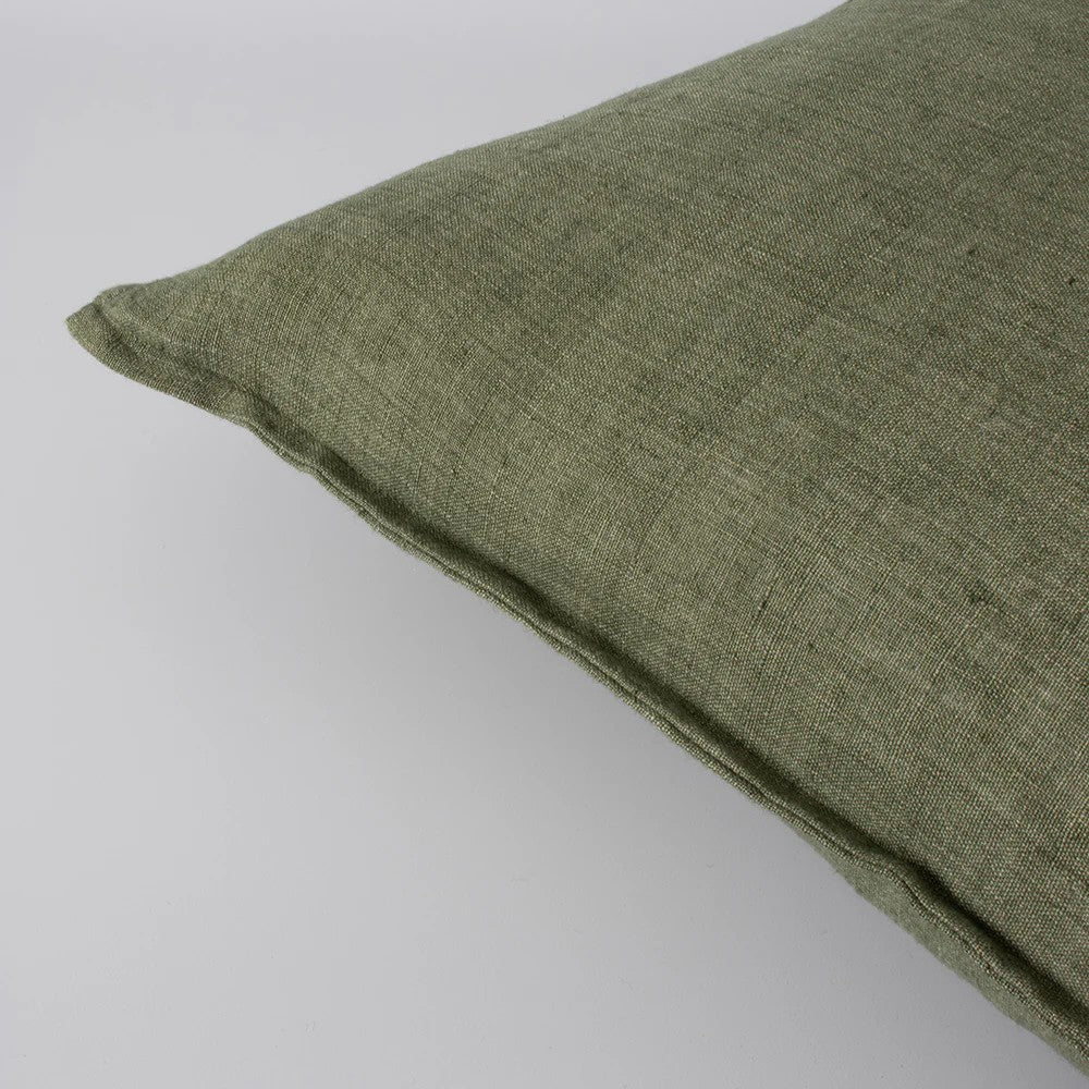 Closeup of moss green linen cushion on a white background