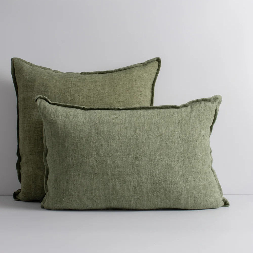 Two moss green linen cushions on a white background