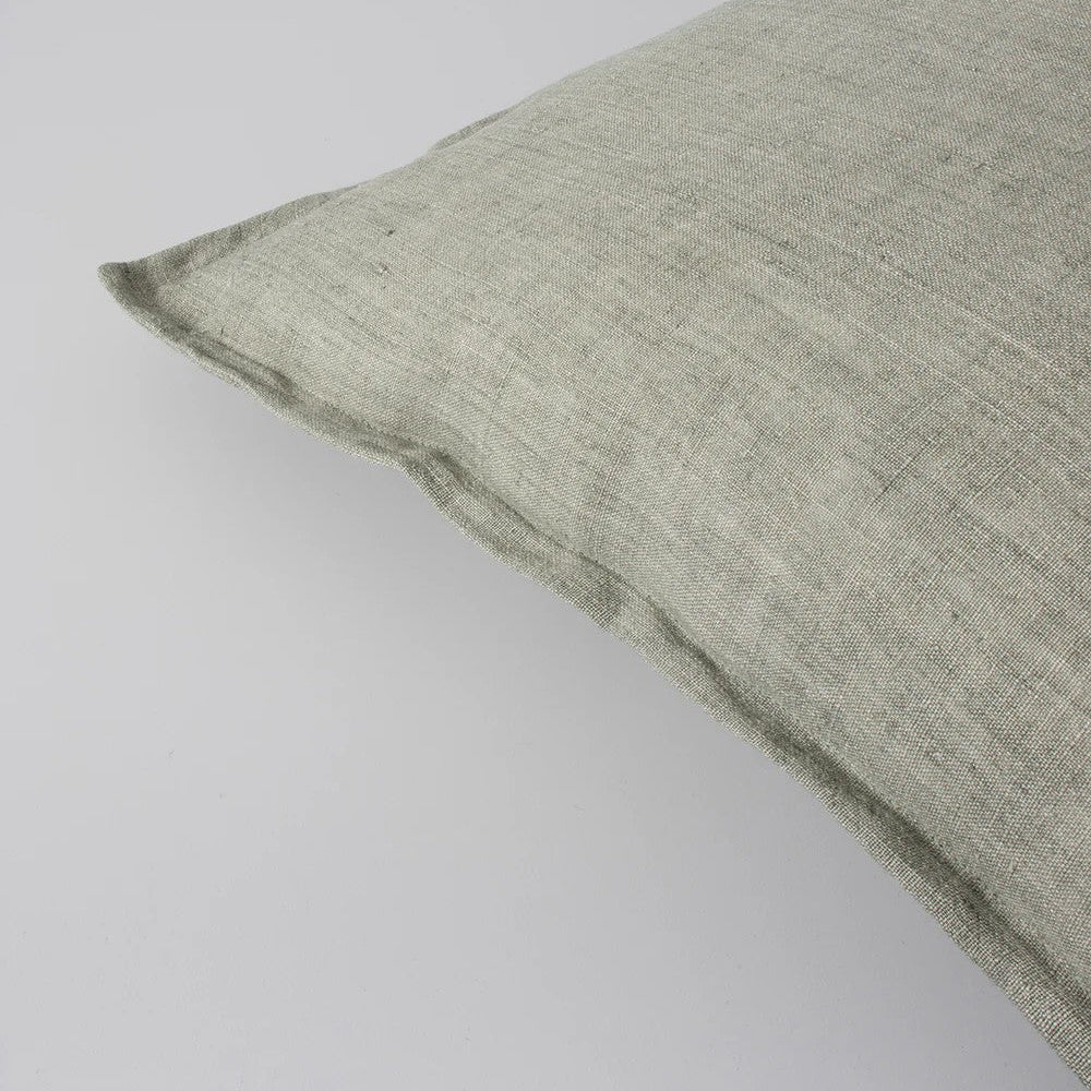 closeup of Green textured linen cushion on a light grey background