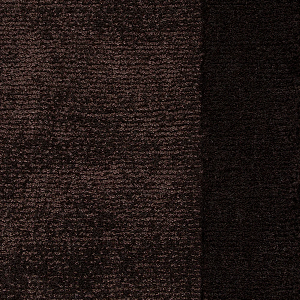 Close-up of chocolate brown textured floor rug with a border detail