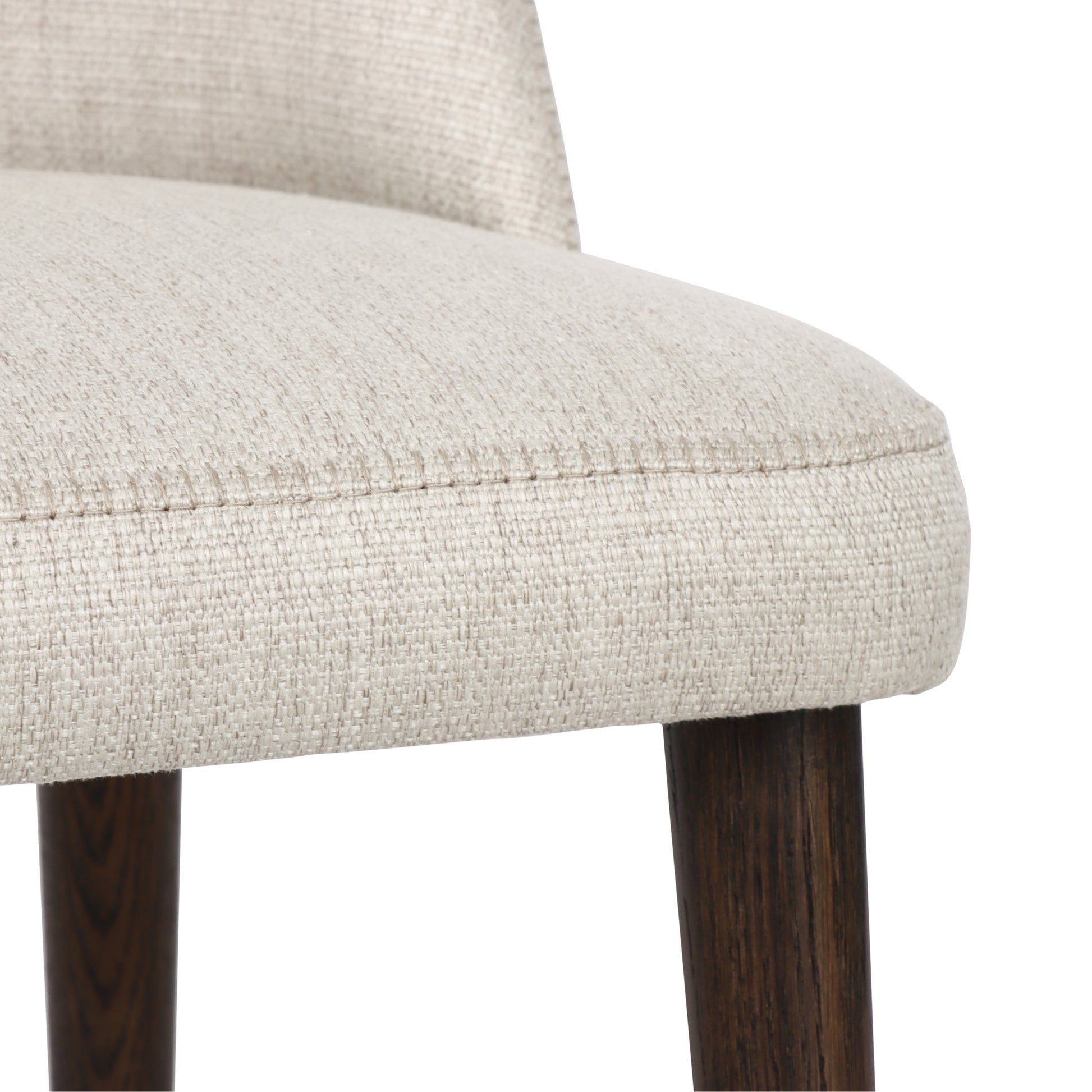Close-up of a chair with beige fabric seat and wooden legs on a white background