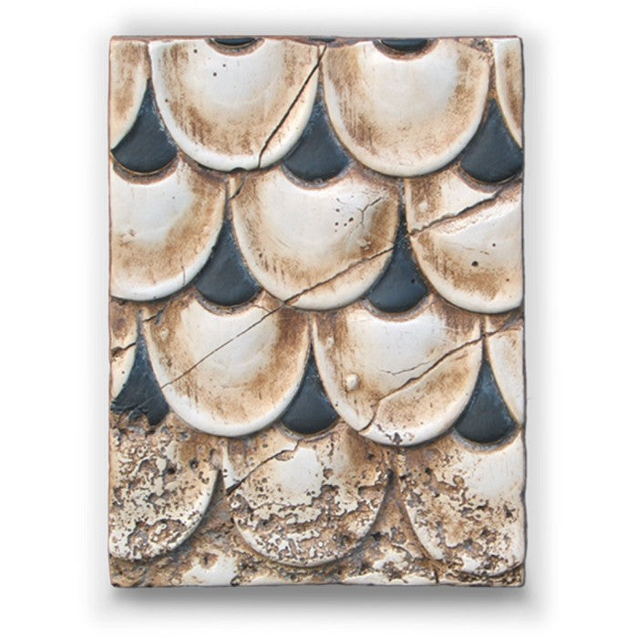 Decorative tile with a pattern of circular shapes in brown, black, and white on a white background