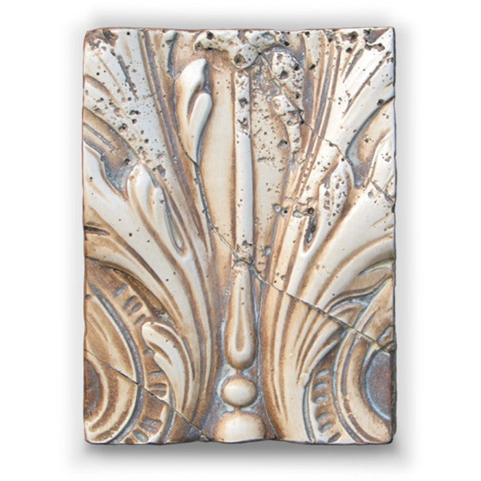 Decorative tile with intricate patterns on a white background