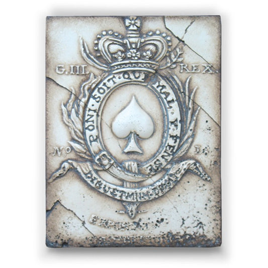 Decorative tile with a spade symbol and crown on a textured background