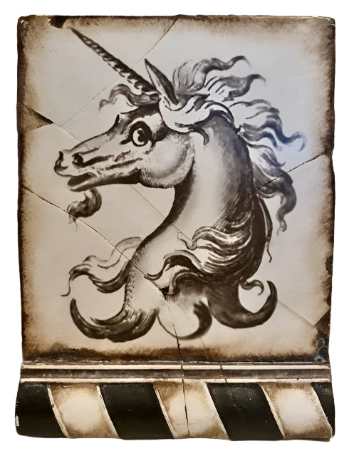 Decorative tile with a unicorn design on a textured surface