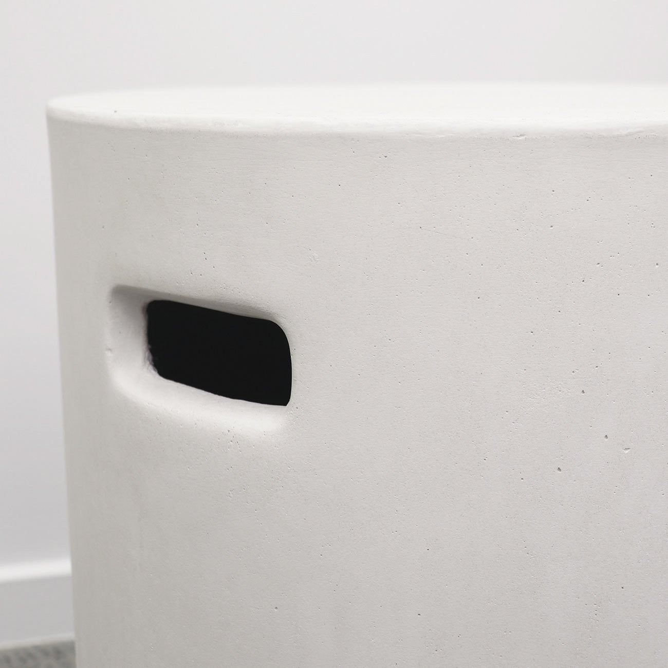 White concrete stool with a handle feature on a white background