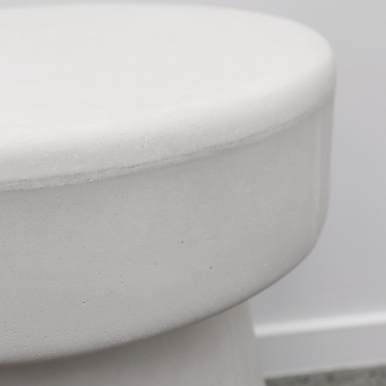 Close-up of a white concrete mushroom stool    