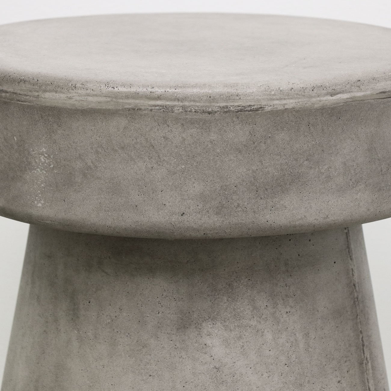 Close up of concrete mushroom side table on a white background