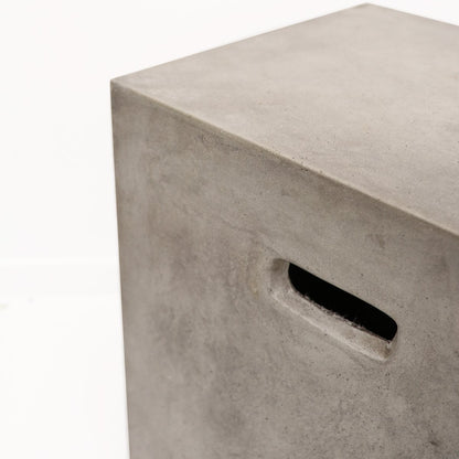 Concrete cube with a rectangular handle hole on a white background
