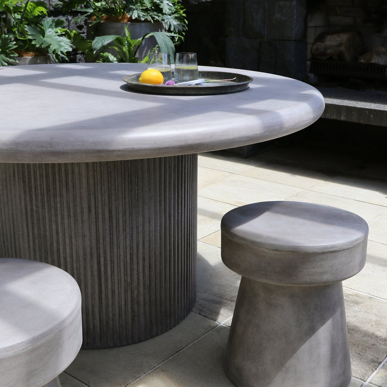 Concrete dining table with stools on a patio