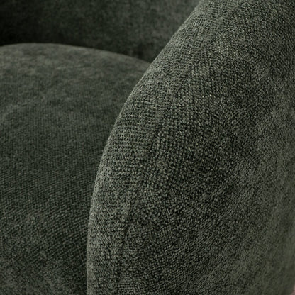 Close-up of textured green fabric surface on a swivel armchair