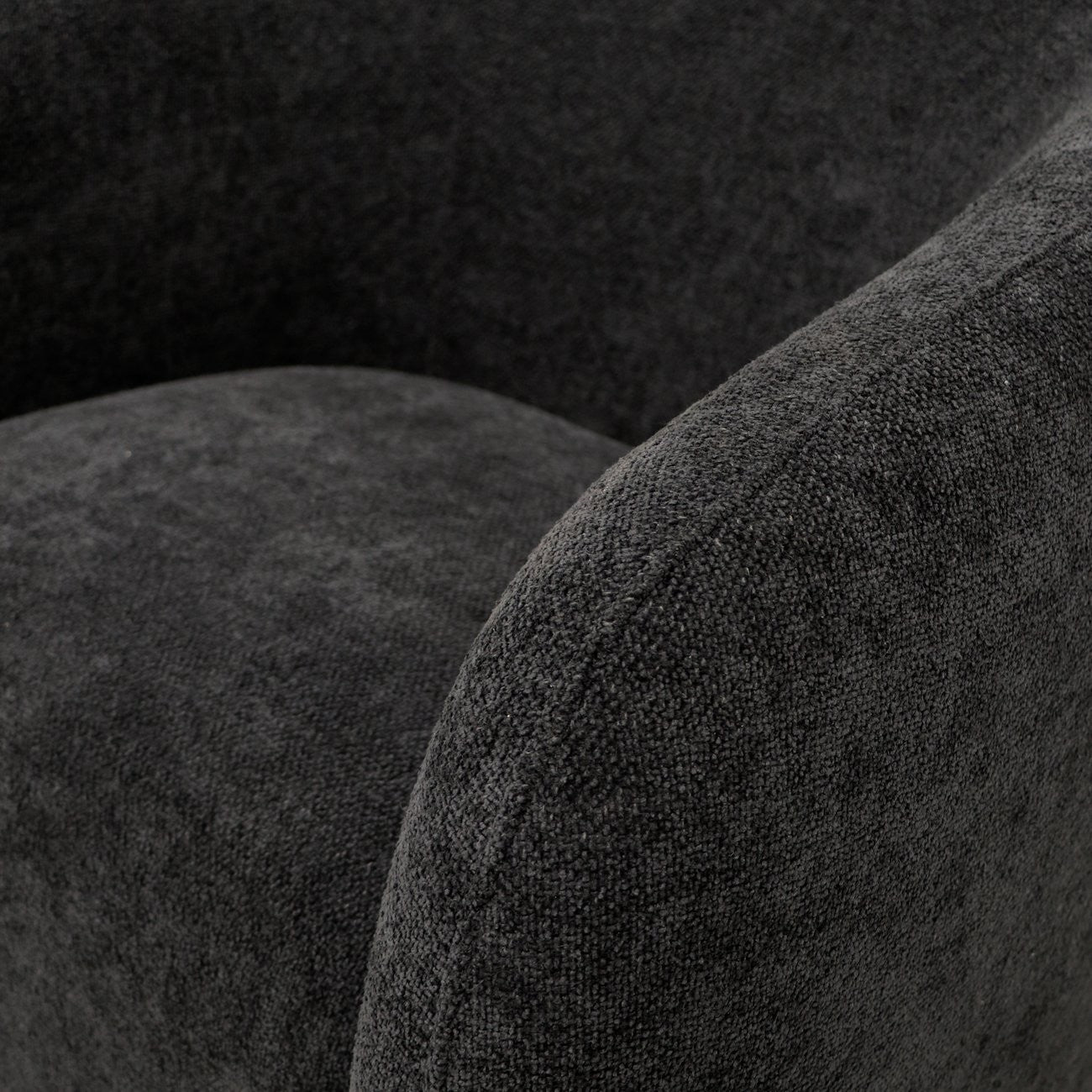 Close-up of a textured black fabric on a swivel armchair 