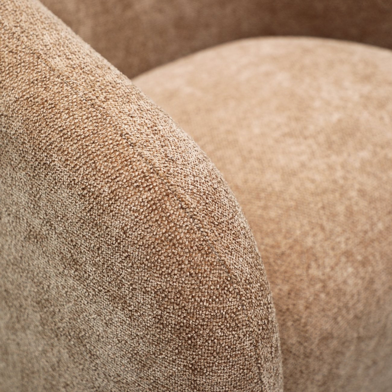 Close up of caramel fabric on a swivel armchair 