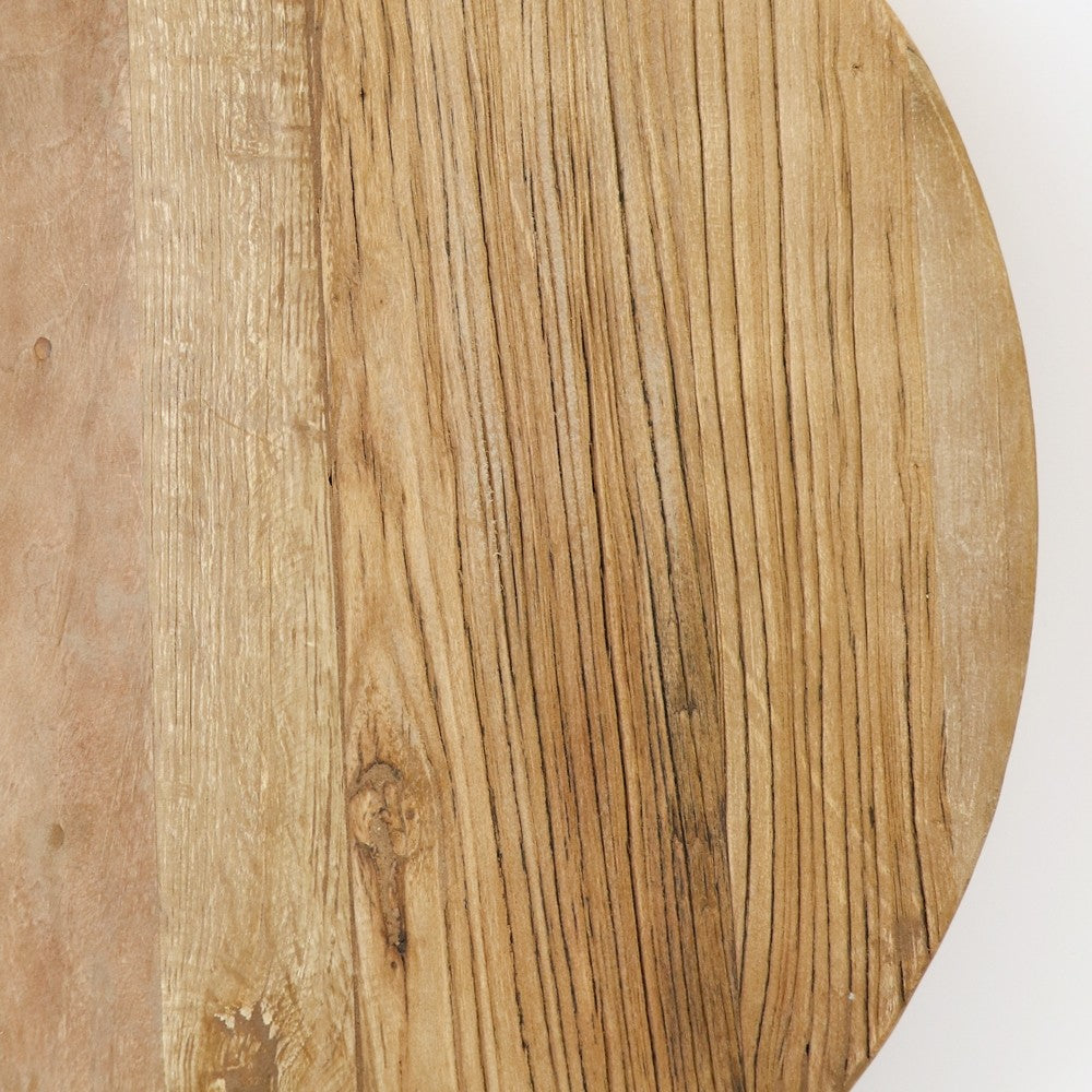 Close-up of a wooden serving board natural light brown colour and visible grain pattern.