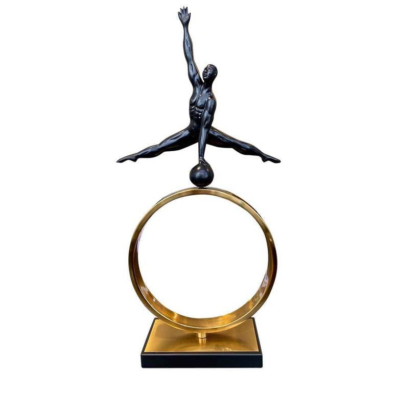Statue of a dancer on a gold ring with a white background