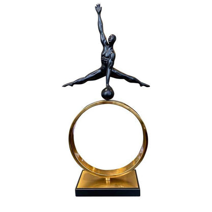 Statue of a dancer on a gold ring with a white background
