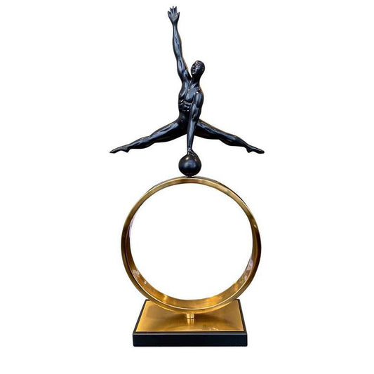 Statue of a dancer on a gold ring with a white background