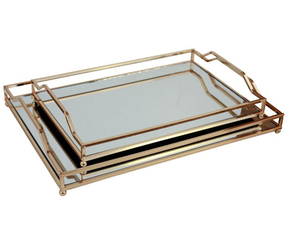 A set of two gold-colored serving trays with iron frames and glass/mirror bottoms.