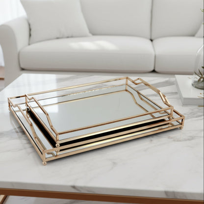 Set of two gold-trimmed glass trays on a white background