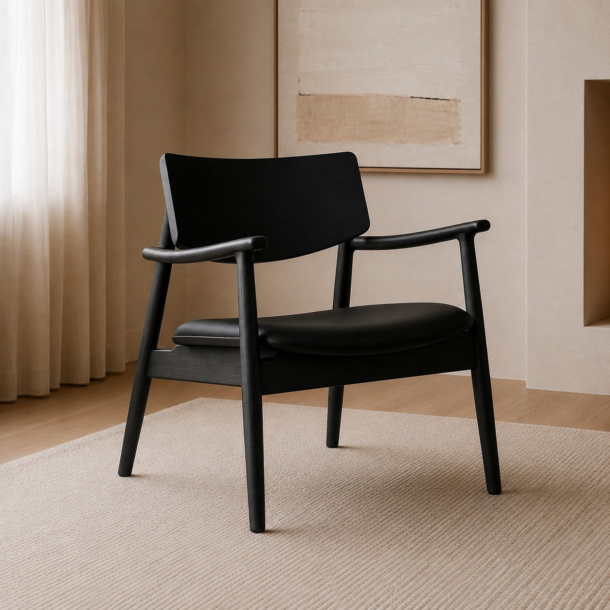 A modern black armchair with a curved wooden armrest and a low backrest, positioned on a textured beige rug in a minimalist room with warm beige walls and curtains.