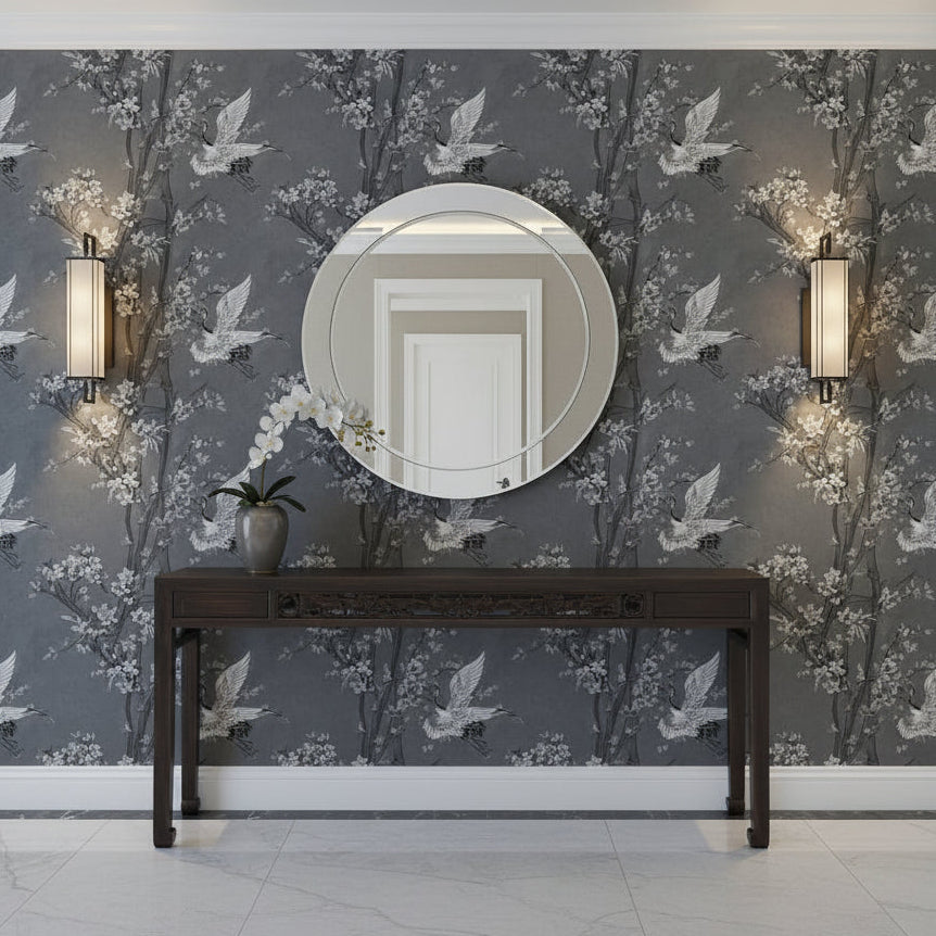 Decorative wall with floral/bird patterned wallpaper, round mirror, and antique Asian Console Table.