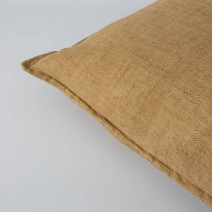Closeup of cumin linen cushion on a white background