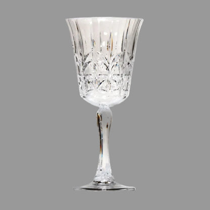 Cut crystal style wine glass on a grey background