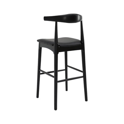 A modern black bar stool with a curved backrest, padded leather seat, and four tapered legs, shown against a plain white background.