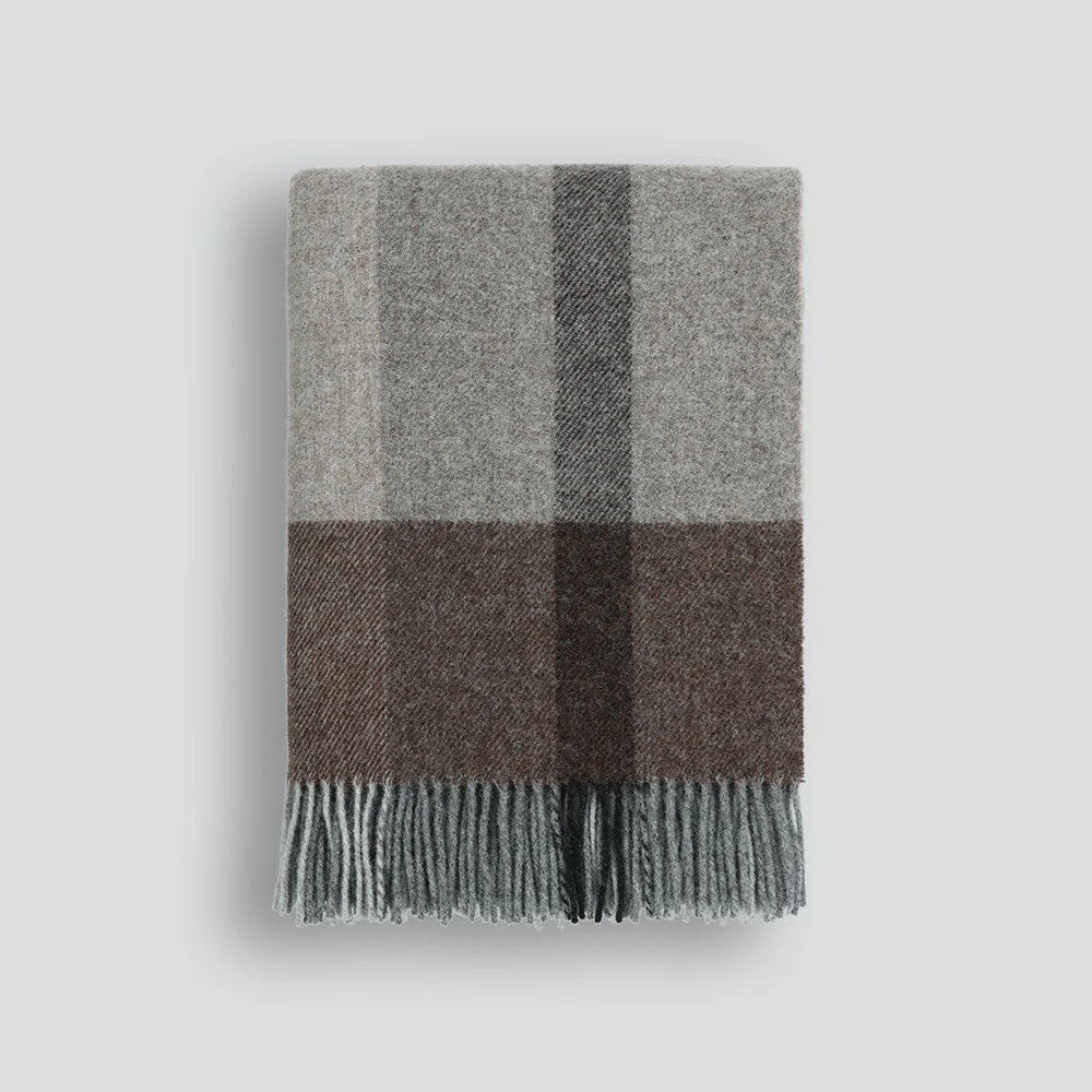 Plaid throw blanket with grey and brown plaid pattern on a white background