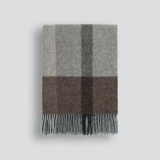 Plaid throw blanket with grey and brown plaid pattern on a white background