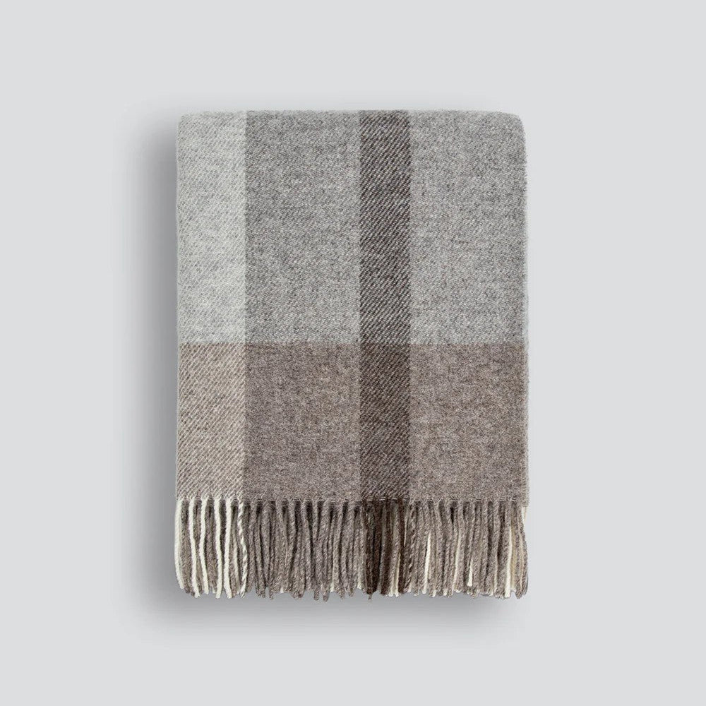 Gray and brown plaid throw blanket on a white background