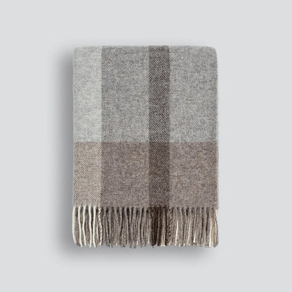 Gray and brown plaid throw blanket on a white background