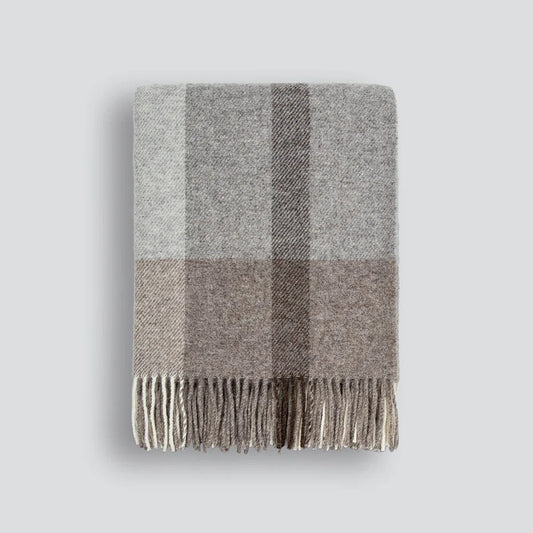 Gray and brown plaid throw blanket on a white background