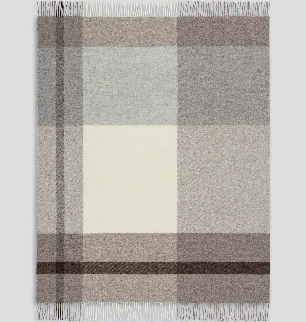 Plaid blanket with brown, grey, and beige colours on a white background