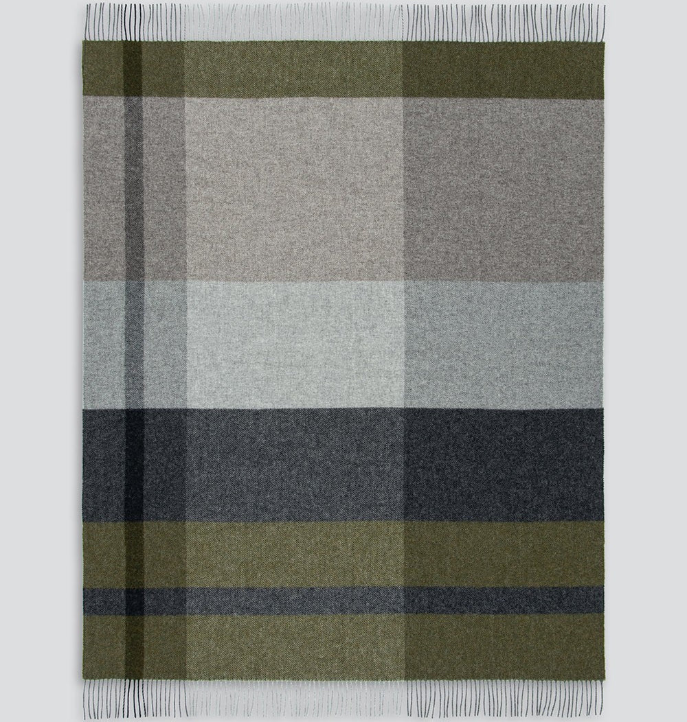 Plaid blanket with green, grey, and dark grey colours on a white background