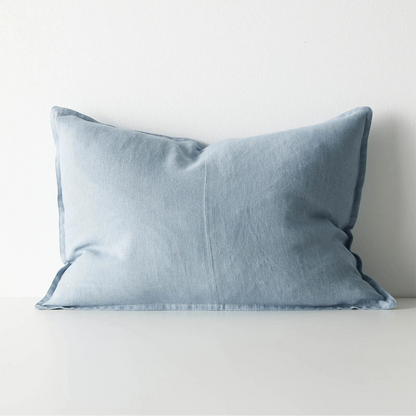 Blue lumbar cushion on a white surface with a light grey background