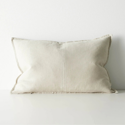 Beige pillow on a white sofa against a white background