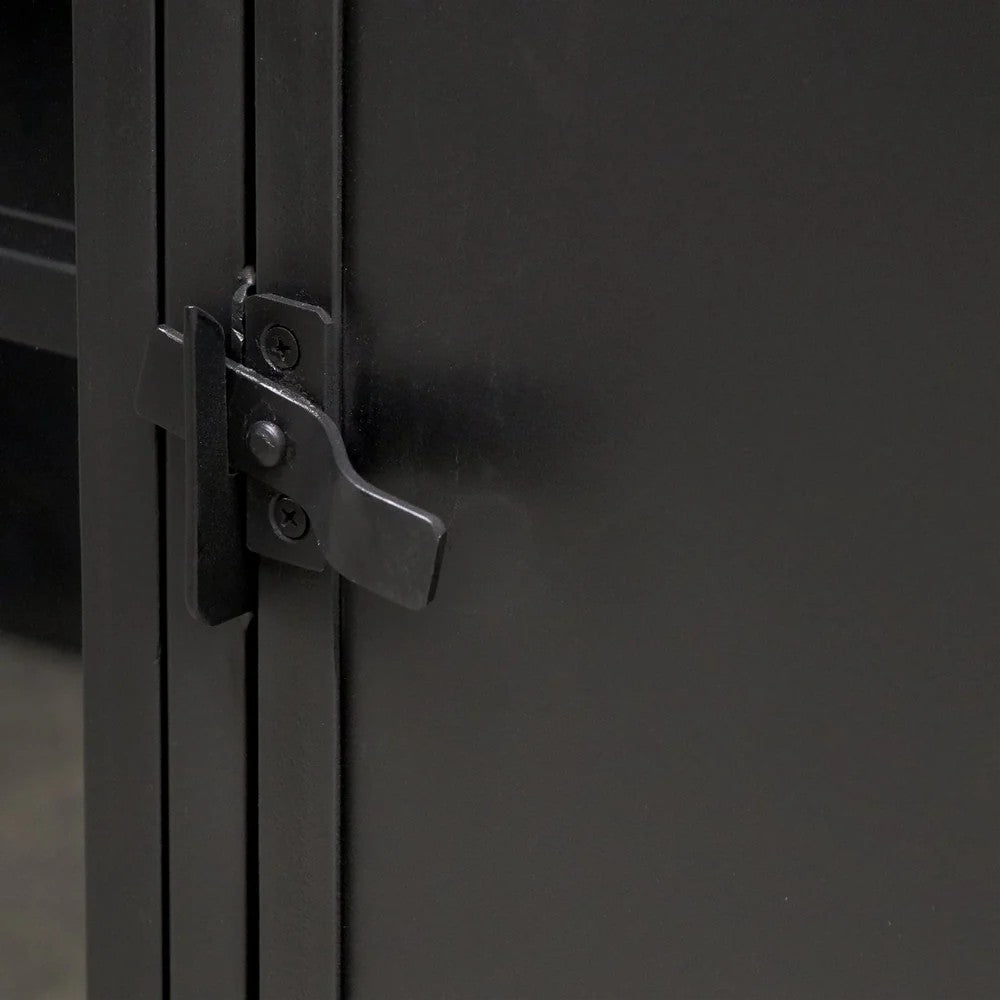 Close-up of a black metal cabinet door latch and lock mechanism.