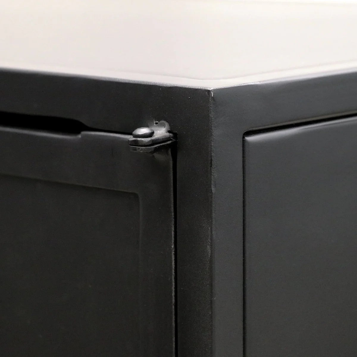 Close-up of a black metal cabinet corner.