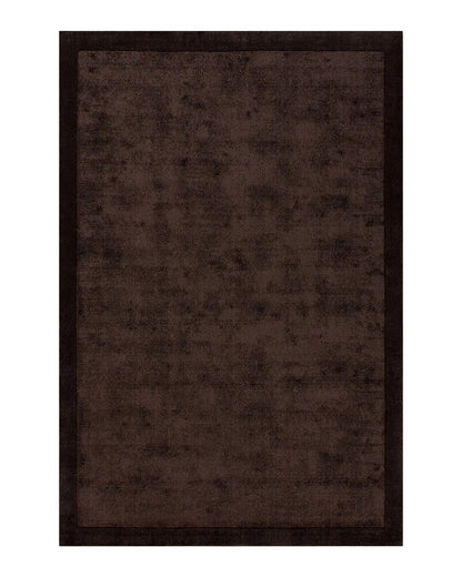 Chocolate brown textured floor rug on a white background