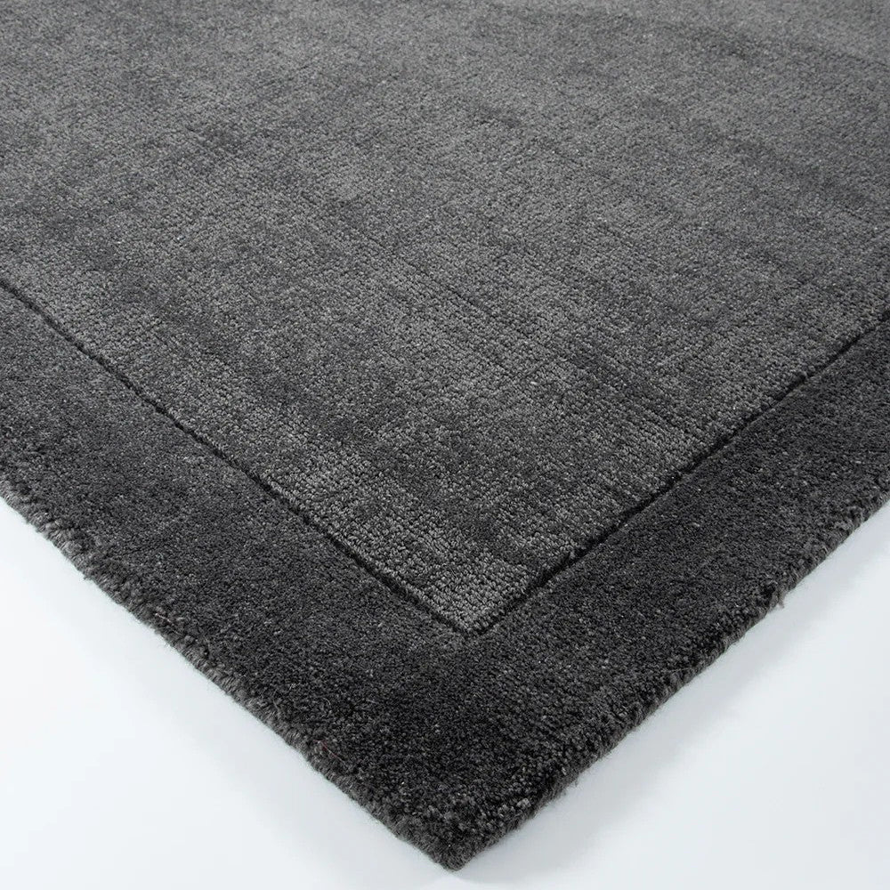 close up on a charcoal floor rug on a white background