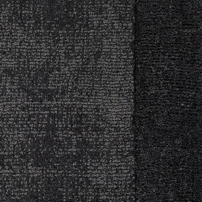Close-up of charcoal textured floor rug with a border detail.