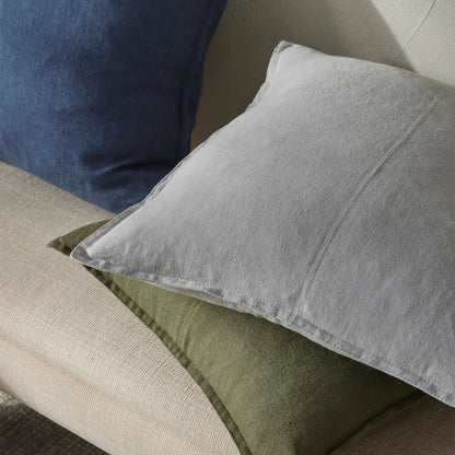 Grey and green cushions on a beige sofa