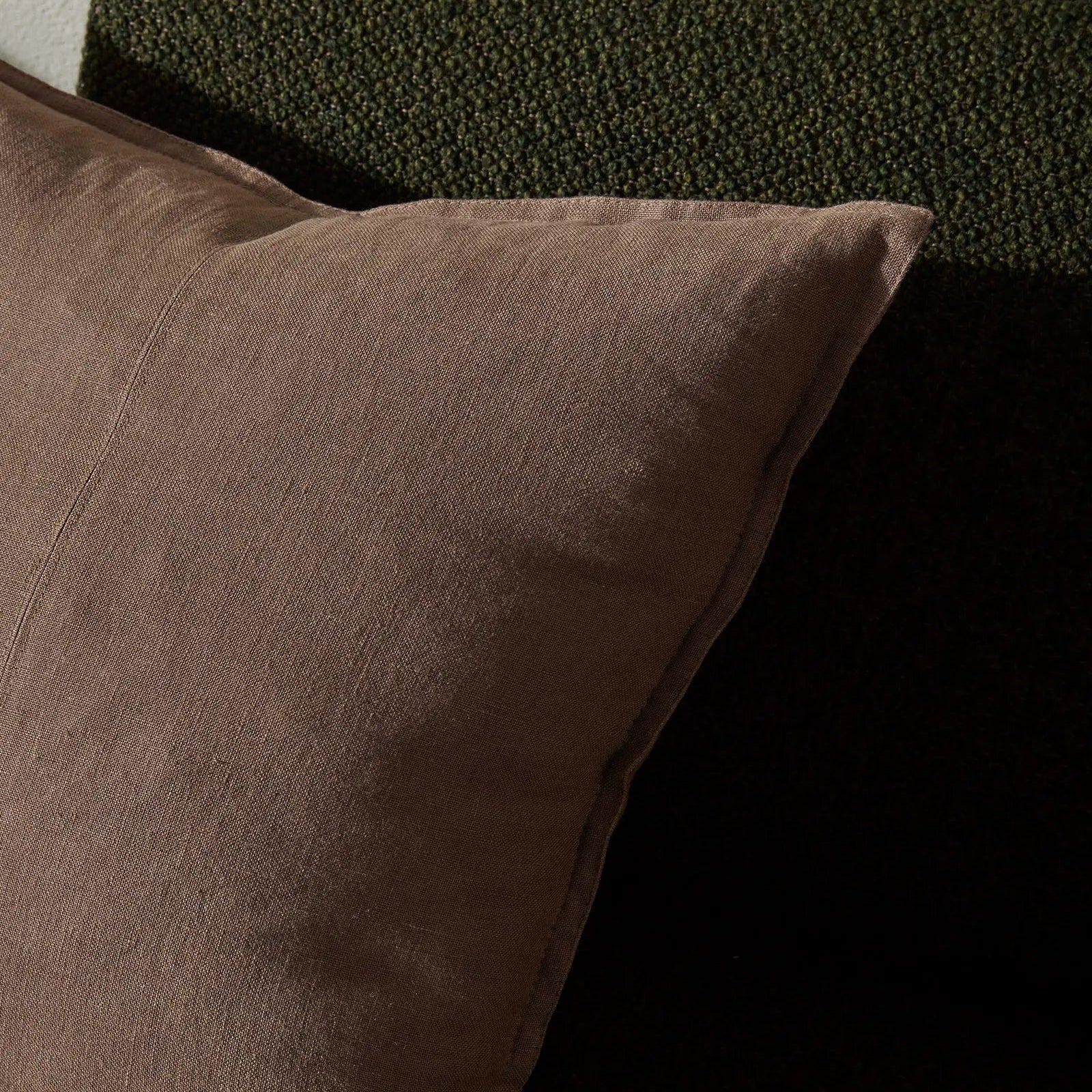 Brown pillow on a dark textured surface