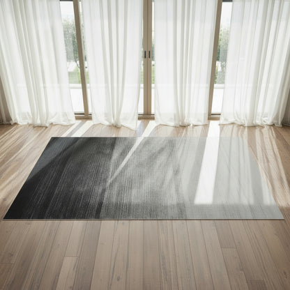 Dusk Floor Rug displayed on a wooden floor with white drapes behind  